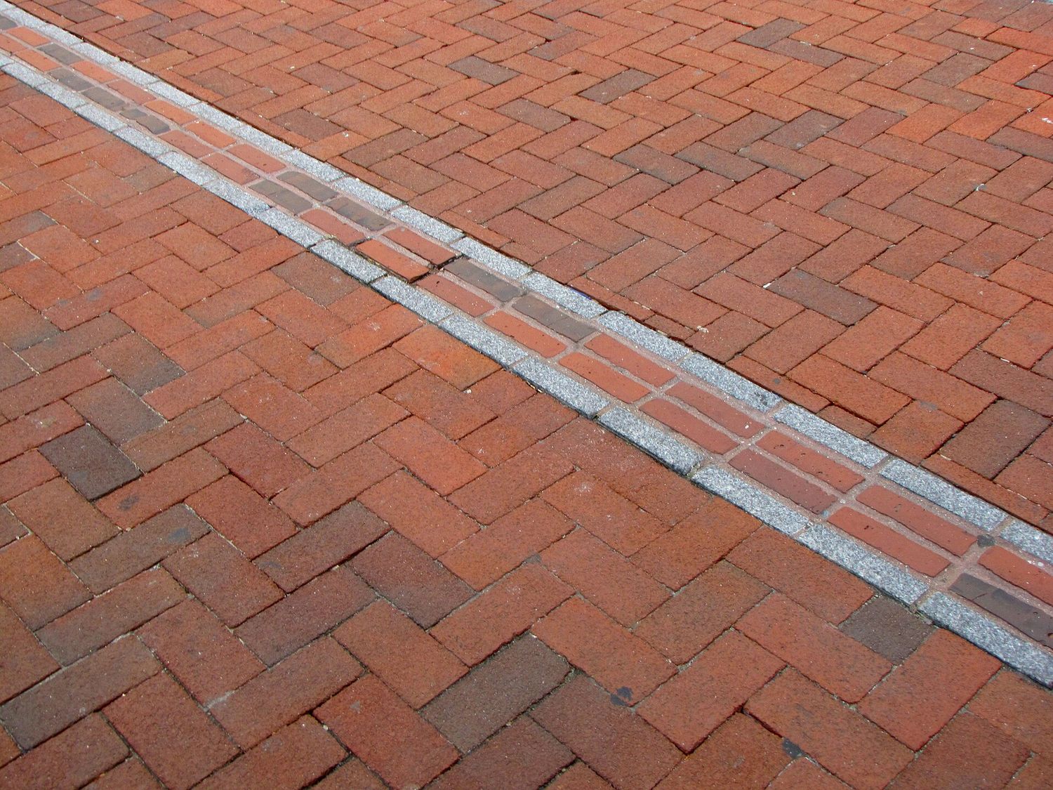 The Freedom Trail's double line of red brick set into a herringbone pavement in downtown Boston.