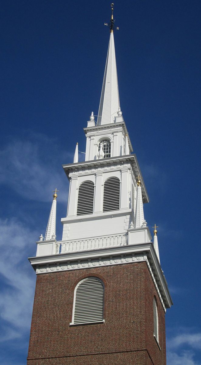 The white steeple of Old North Church rising above the brick rooftops and chimneys of Boston's North End.