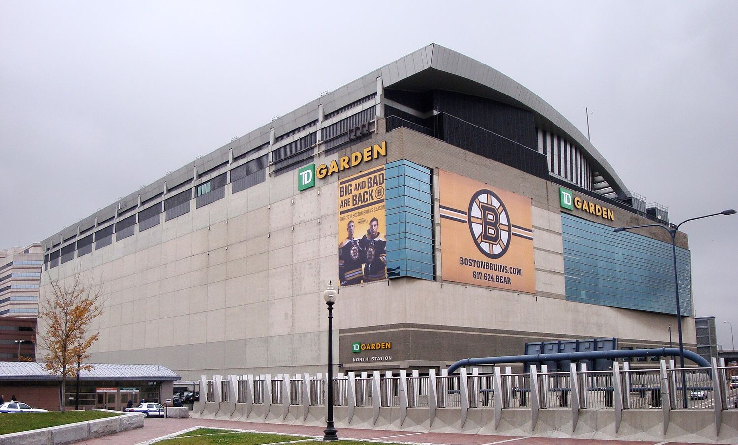 The exterior of TD Garden in Boston on an overcast day, a large concrete and glass arena with the North Station entrance at street level beneath it.