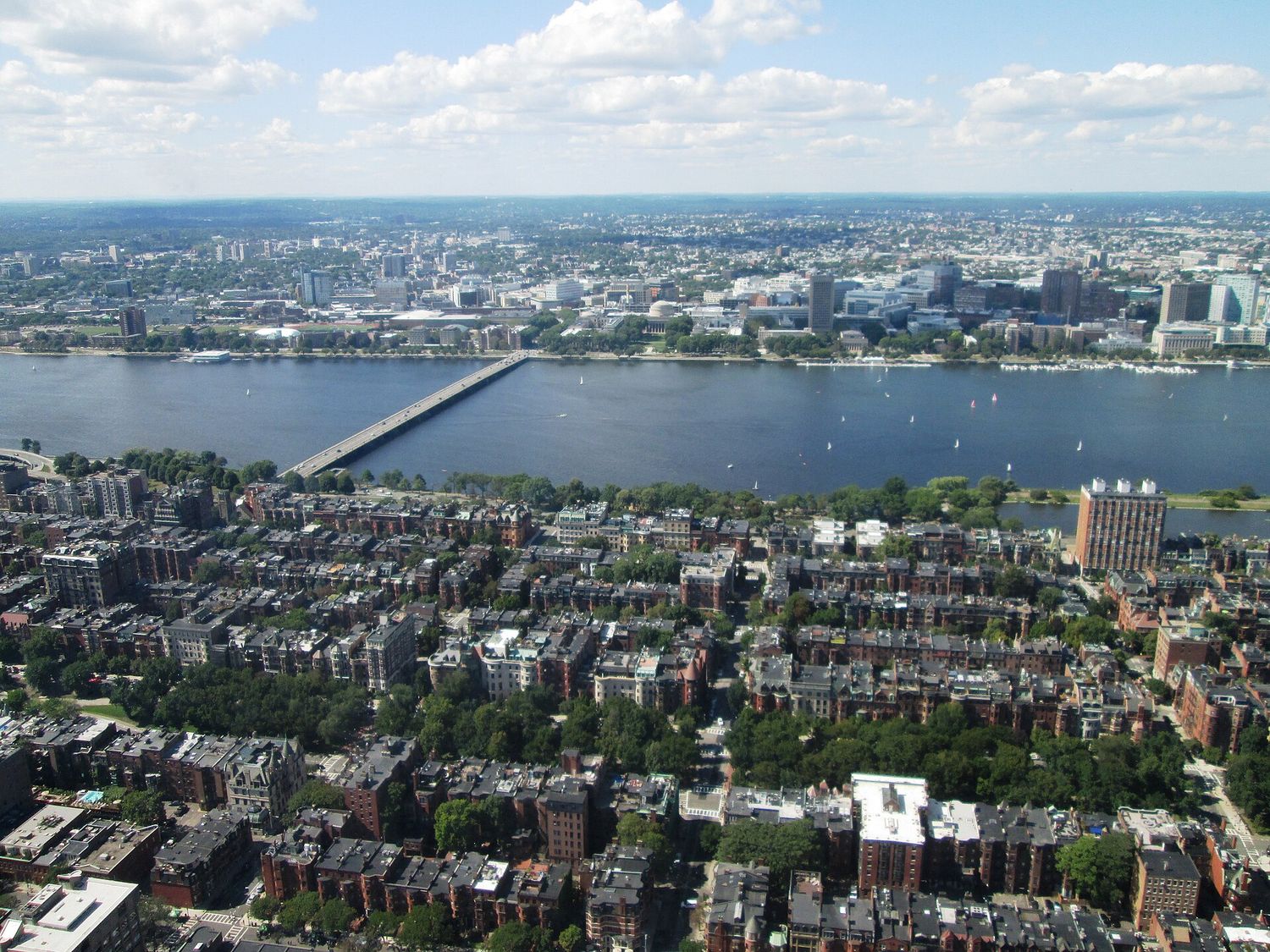 The view north from the top of the Prudential Tower over the rooftops of Back Bay to the Charles River, the Harvard Bridge and the MIT campus in Cambridge beyond.